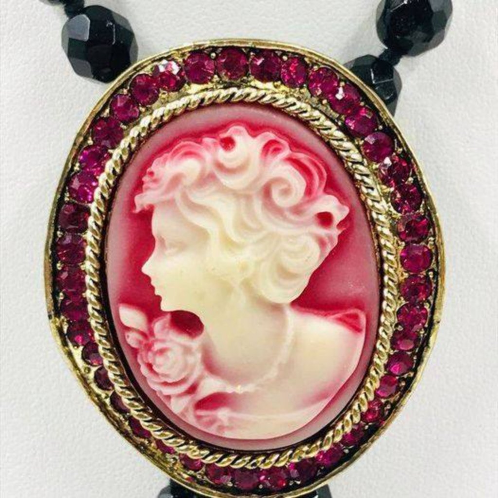 Red Wavy Cameo Brooch With Pink Crystals Along The Perimeter.